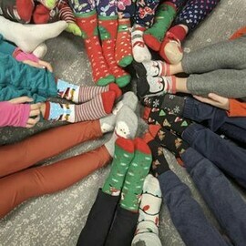 Several students pictured (only feet) displaying their festive socks.